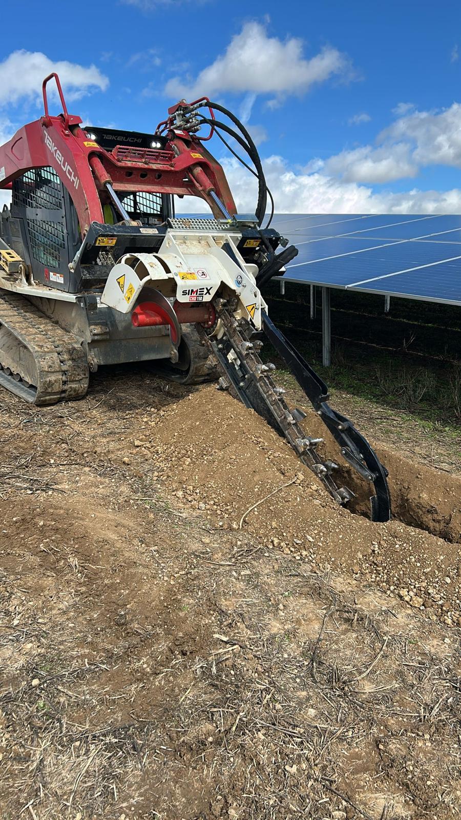 Roter Takeuchi Kettendumper mit Simex Grabenfräse